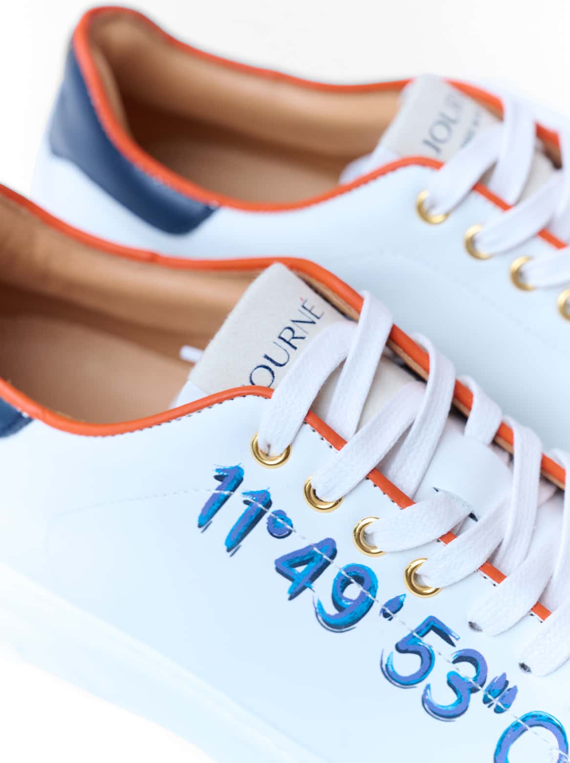 Koordinatenprägung in Blau auf weißem Kalbsleder – Detailaufnahme Petra Sneaker
